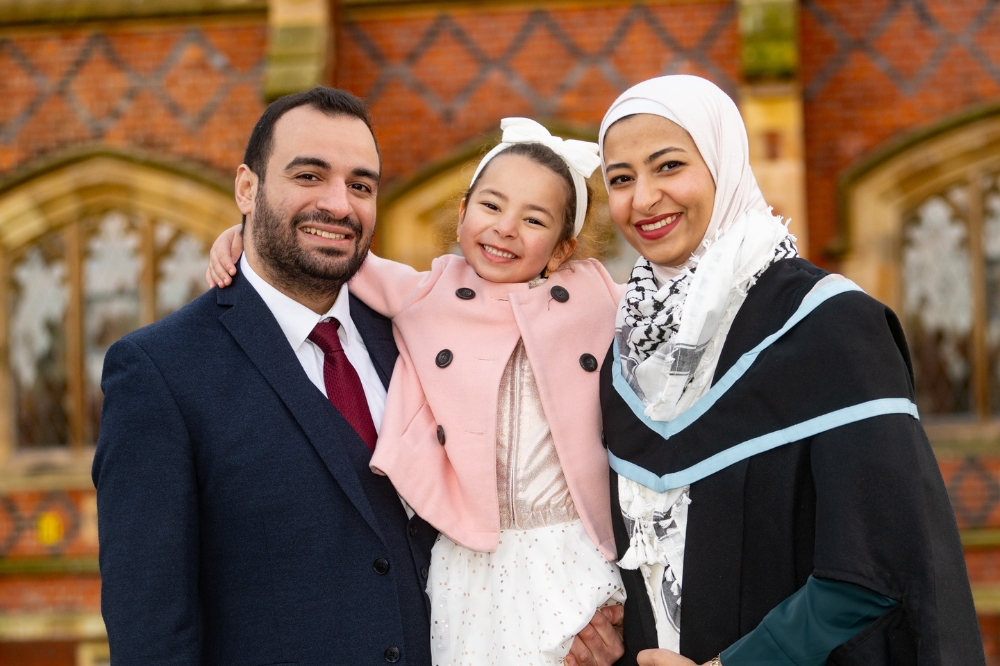 International female graduate celebrates with family at Winter graduation 2023