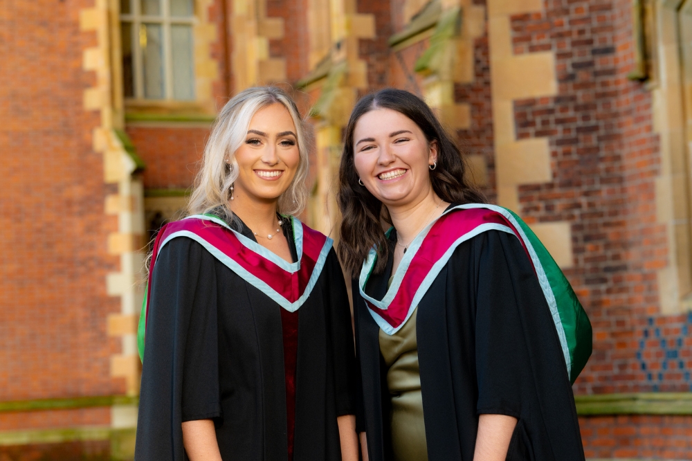 two new smiling female graduates celebrating at Winter graduation 2023