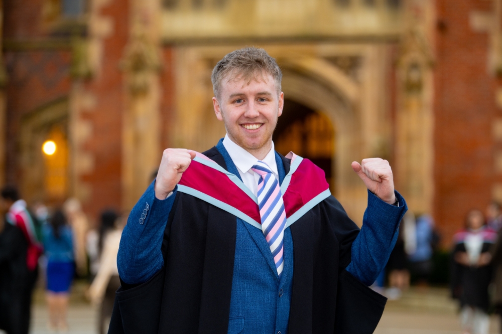 new male graduate smiling and raising his fists at Winter Graduation 2023