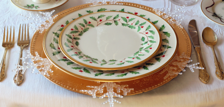 Christmas dinner table setting with china plates