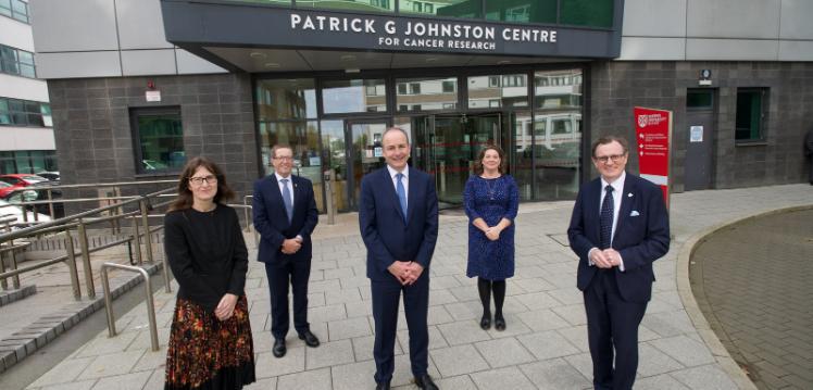 Taoiseach Micheal Martin and Queen's staff outside Cancer Centre
