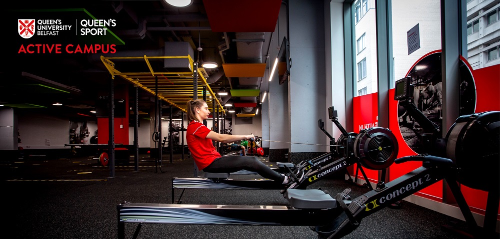 young woman using a rowing machine in a gym