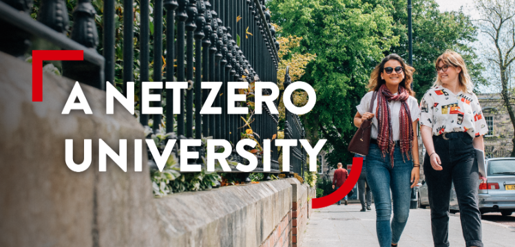 Two students smiling as they walk along University Square with greenery in the background and a graphic that reads: A net zero university