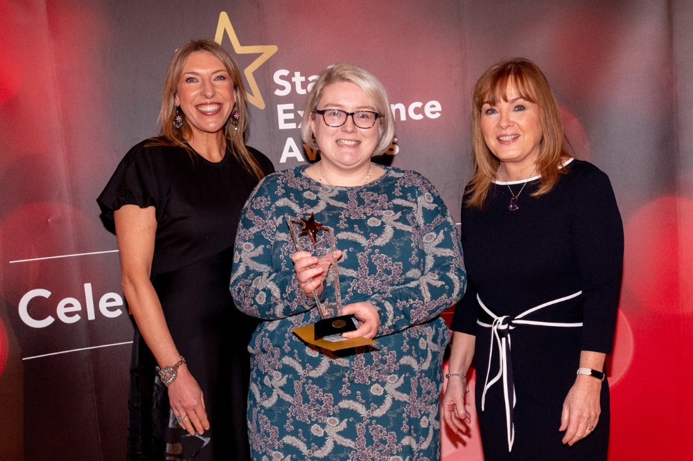 Helen Browne, Delivering Excellence Award winner (centre), with compere Alexandra Ford and Mairead Regan, Chair of the Staff Excellence Awards Judging Panel