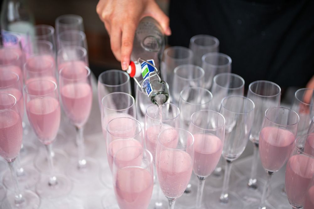 sparkling refreshment being served at Queen's Carers Week barbecue on the quadrangle, June 2023