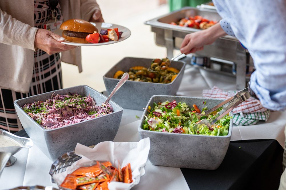 food being served at Queen's Carers Week barbecue on the quadrangle/cloisters, June 2023