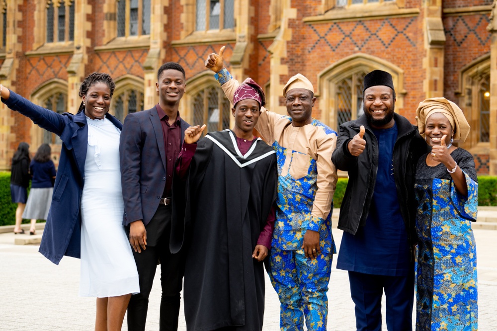 International student graduating with family in colourful attire