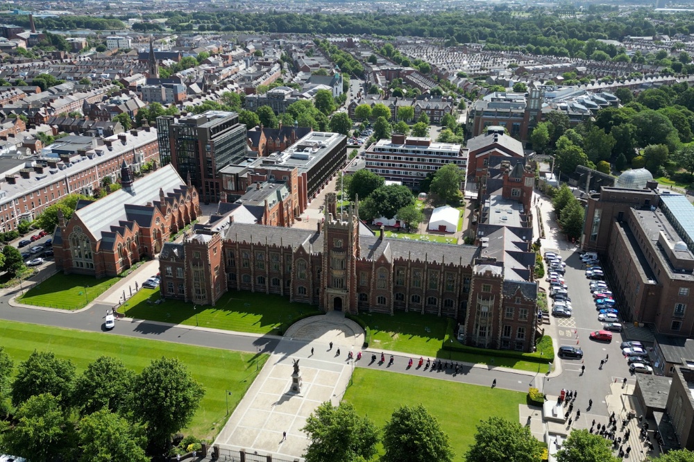 aerial view of Lanyon Building, Queen's University Belfast, and surrounds, showing academic procession and graduation marquees - summer graduations 2023
