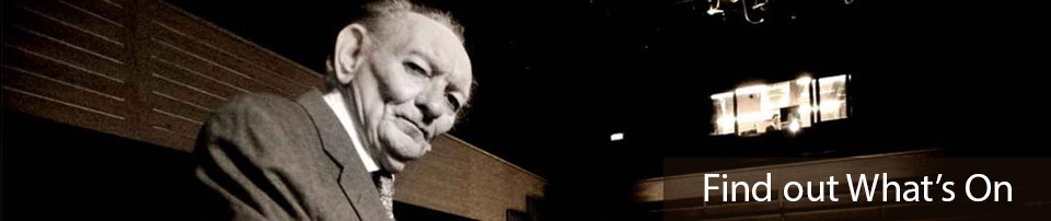 Image of Brian Friel in a theatre, with the text Find out What's On
