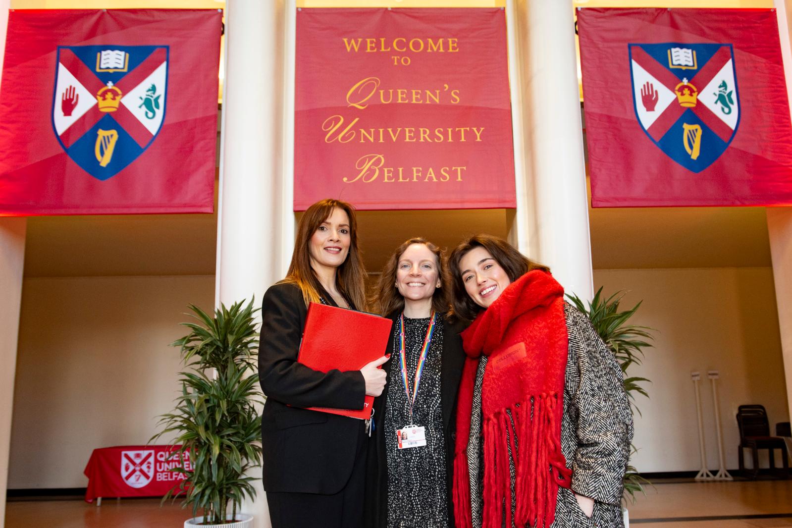 Queen's University Belfast conferencing team posing together for a group photo, smiling and ready for an event.