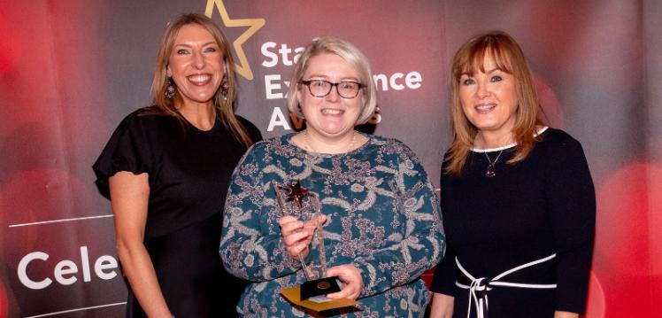 Helen Browne, Delivering Excellence Award winner (centre), with compere Alexandra Ford and Mairead Regan, Chair of the Staff Excellence Awards Judging Panel