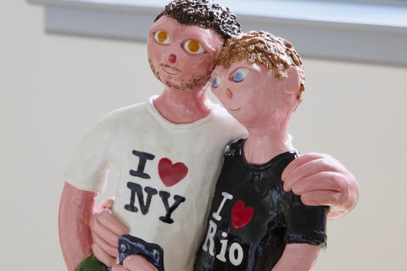 clay sculpture exhibit from Naughton Gallery's 'The Big Neighbourhood' exhbition, portraying two people wearing 'I heart' t-shirts
