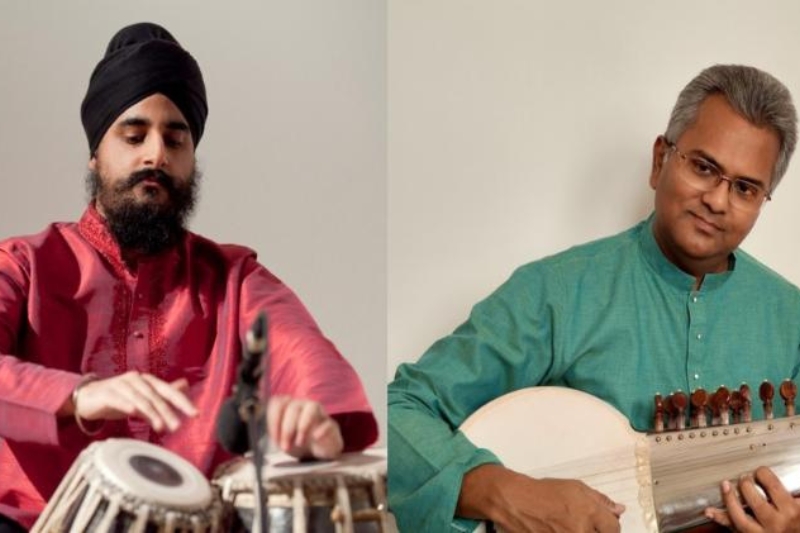 man on left wearing turban and playing tabla and man on right playing a sarode