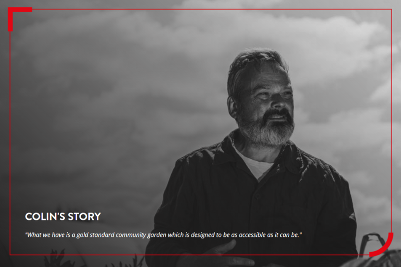 Black and white photo of a man standing in a field on a sunny day