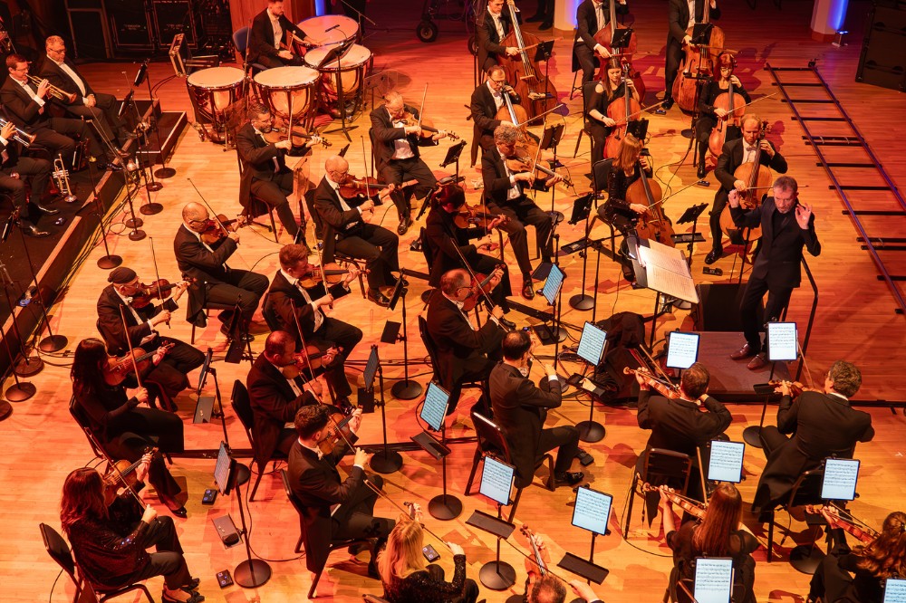 view from above of an orchestra playing in a large hall
