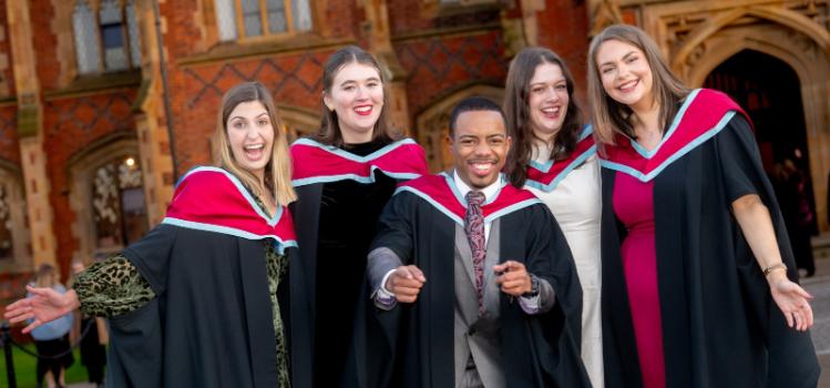 five smiling new graduates celebrating